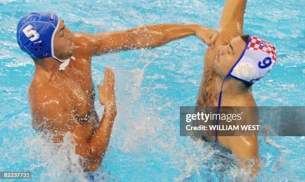 Valinto Gallo of Italy hits Croatia's Pavo Markovic after throwing the ball during their men's water polo match at the 2008 Beijing Olympics, on...