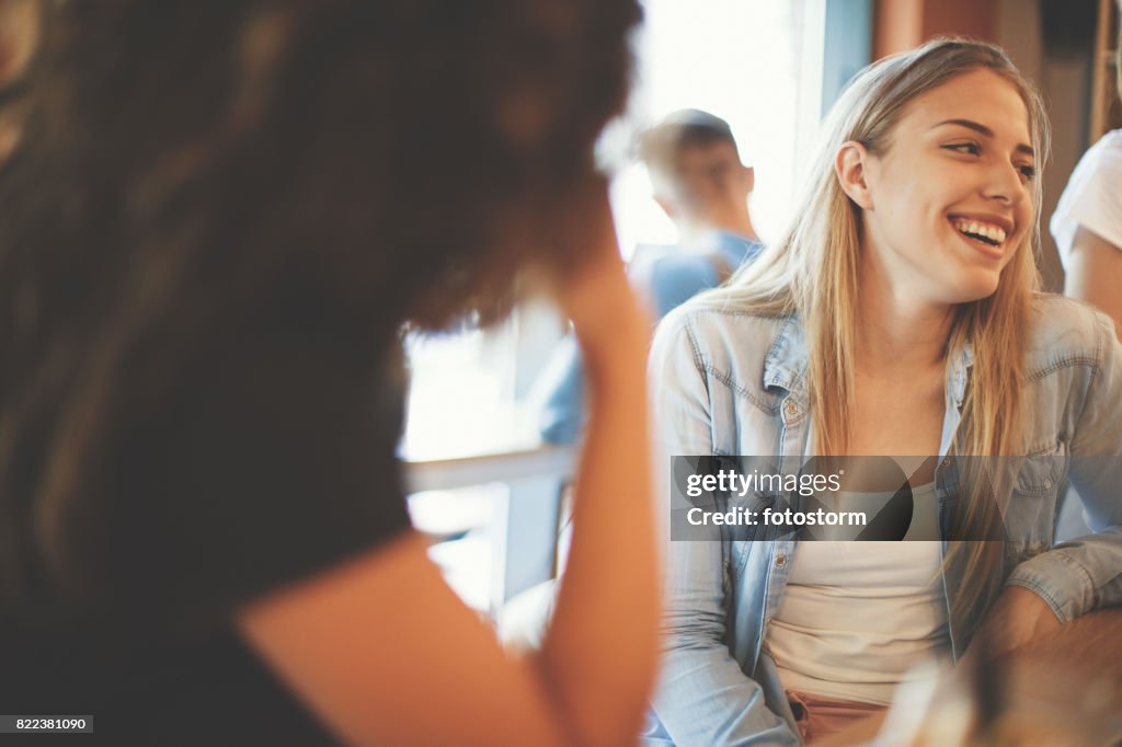 Friends laughing in a cafe