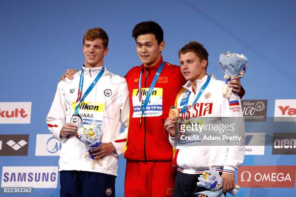Silver medalist Aleksandr Krasnykh of Russia, gold medalist Yang Sun of China and bronze medalist Townley Haas of the United States pose with the...