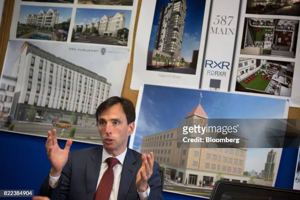 Noam Bramson, mayor of New Rochelle, speaks in front of renderings of RXR Realty high-rise apartment building during an interview at City Hall in New...