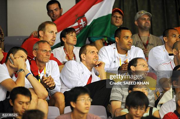 Germany's key basketball player Dirk Nowitzki watches his country's handball team match against Korea during the 2008 Beijing Olympic Games men's...