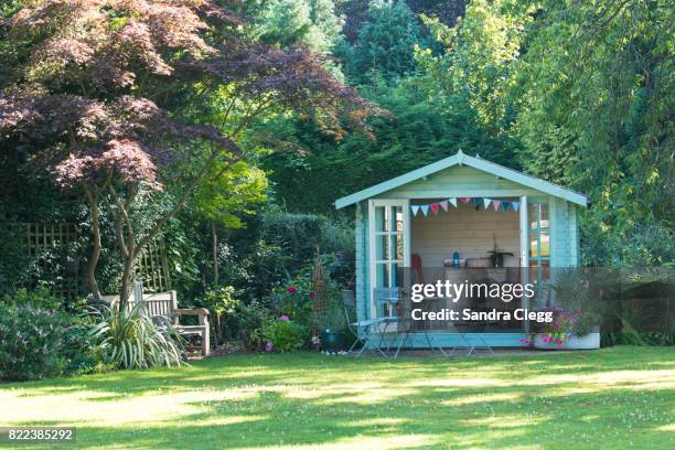 summer in the garden with the summer house - cabana stockfoto's en -beelden