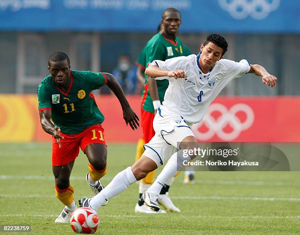 Gustave Bebbe of Cameroon and Rigoberto Padilla of Honduras compete for the ball during the Men's Group D match between Cameroon and Honduras on Day...