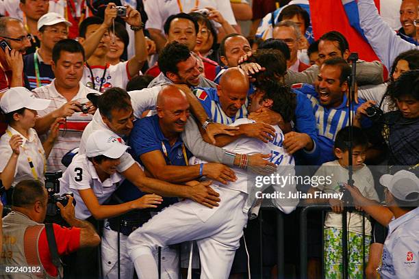 Matteo Tagliariol of Italy celebrates his gold medal with fans after defeating Fabrice Jeannet of France in the fencing event held at the Fencing...