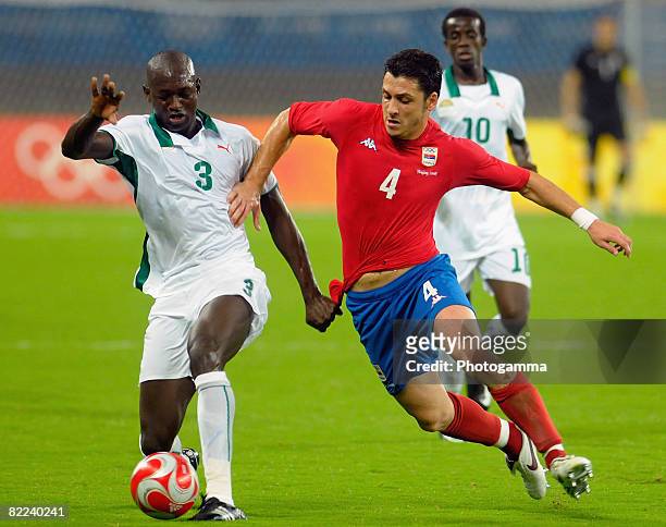 Ousmane Viera Diarrassouba of Ivory Coast and Gojko Kacar of Serbia compete for the ball during the Men's Group A match between Serbia and Ivory...
