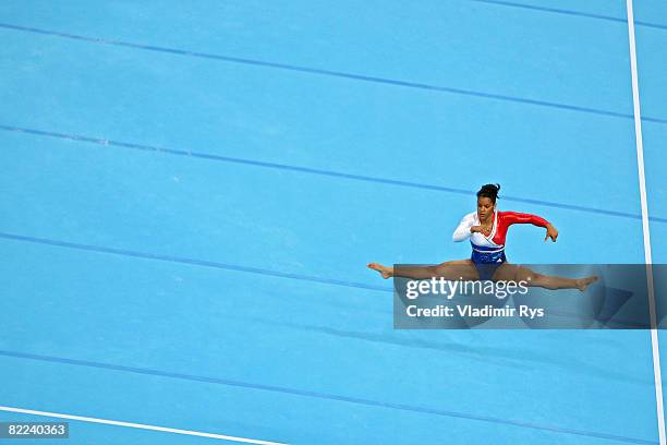 Laetitia Dugain of France perfroms her floor exercise during the qualification round for the women's artistic gymnastics event held at the National...