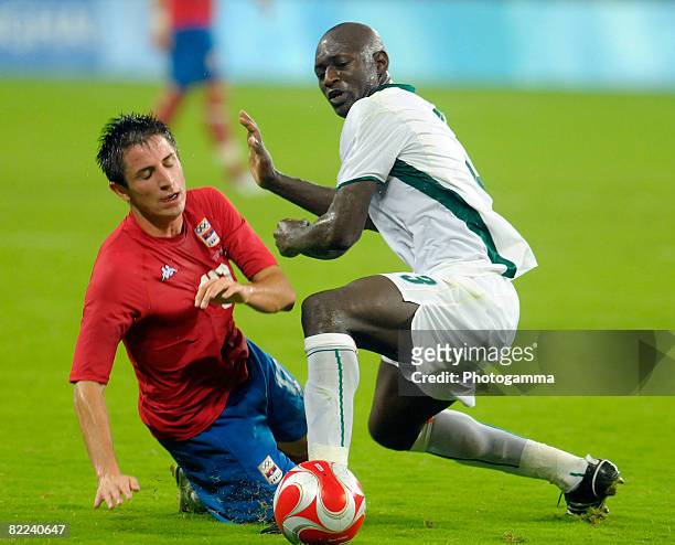 Ousmane Viera Diarrassouba of Ivory Coast and Zoran Tosic of Serbia compete for the ball during the Men's Group A match between Serbia and Ivory...