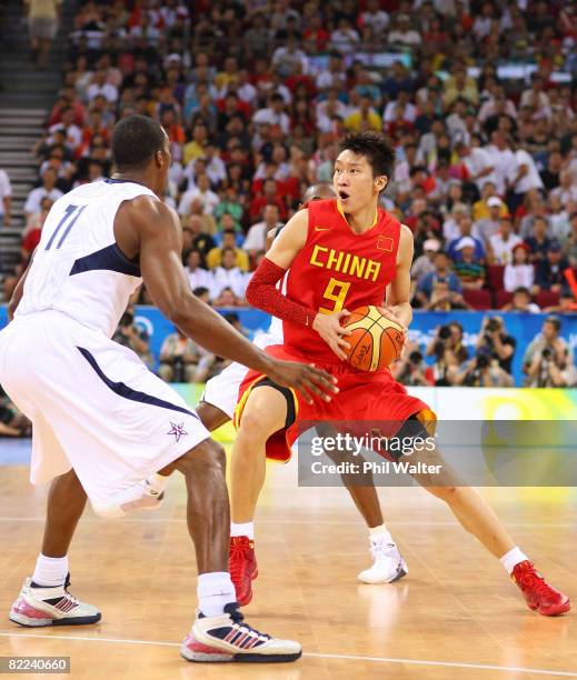 Sun Yue of China looks for an opening around Dwight Howard of the United States during the day 2 preliminary game at the Beijing 2008 Olympic Games...