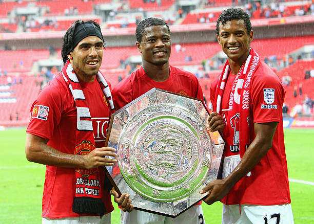 Luis Nani, Patrice Evra and Carlos Tevez of Manchester United celebrate with the trophy as they are victorious on penalty kicks during the FA...