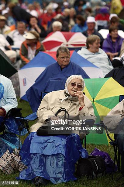 Elderly people with umbrellas attend the Rimpelrock festival, in Kievit, Hasselt, on August 10, 2008. The Rimpelrock festival aims at the over...