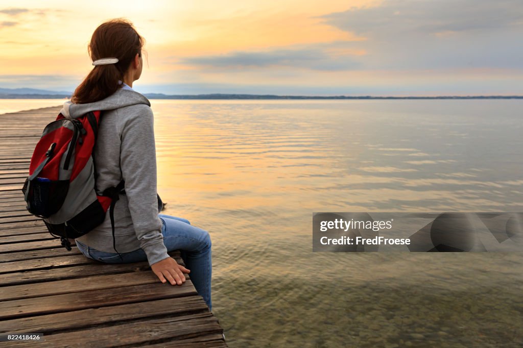 Backpacker on wooden jetty