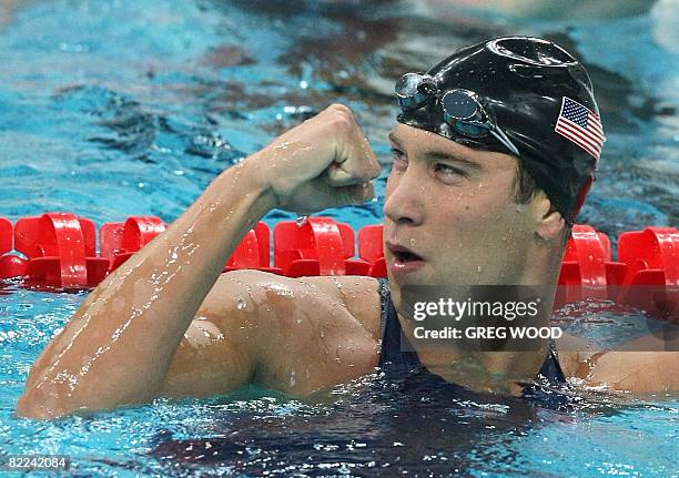 Swimmer Nathan Adrian celebrates after setting a new world record in the men's 4x100m freestyle relay swimming heat at the National Aquatics Center...