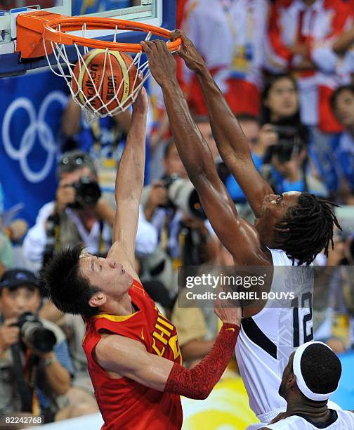 Us chris bosh dunks in front of chinas yue sun during the mens preliminary round group b Us chris bosh dunks in front of chinas yue sun during the mens preliminary round group b