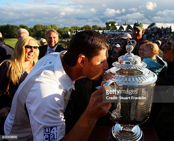 Padraig Harrington of Ireland kisses the PGA Championship Trophy as he walks up the players runway after exiting the 18th green having finished...