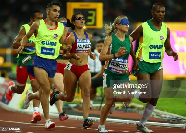 Margarita Faundez of Chile and Guida Francisco Munoz and Louzanne Coetzee of South Africa and Guida Voight Mikone compete Women's 1500m T11 Final...