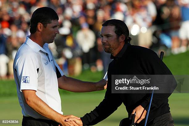 Padraig Harrington of Ireland and Sergio Garcia of Spain shake hands after completing the final round of the 90th PGA Championship at Oakland Hills...