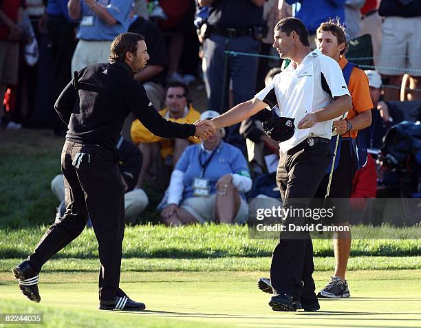 Sergio Garcia of Spain and Padraig Harrington of Ireland shake hands after completing the final round of the 90th PGA Championship at Oakland Hills...