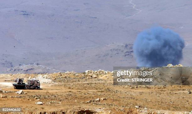 Smoke billows in a mountainous area around the Lebanese border town of Arsal on July 25, 2017 as seen during a press tour organised by Lebanese...