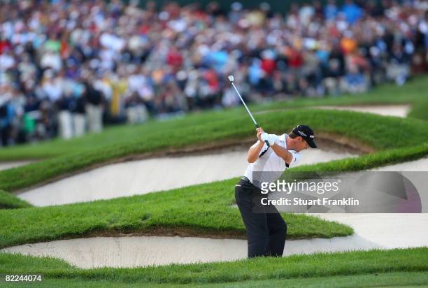 Padraig Harrington of Ireland plays from a bunker in the fairway of the 18th hole during the final round of the 90th PGA Championship at Oakland...