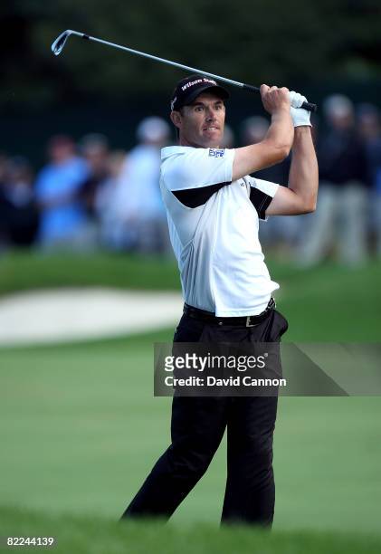 Padraig Harrington of Ireland watches his third shot on the 18th hole during the final round of the 90th PGA Championship at Oakland Hills Country...