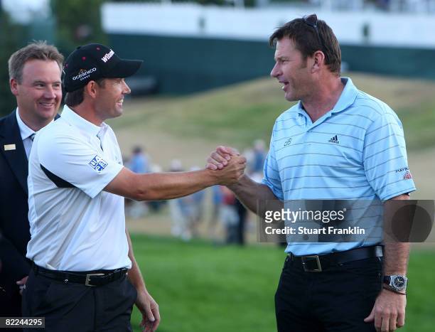 Padraig Harrington of Ireland is congratulated by Nick Faldo of England after the final round of the 90th PGA Championship at Oakland Hills Country...