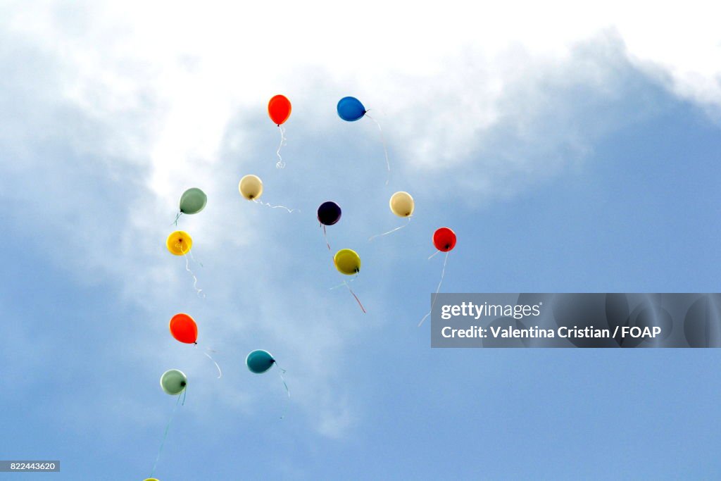 Low angle view of balloons flying in air