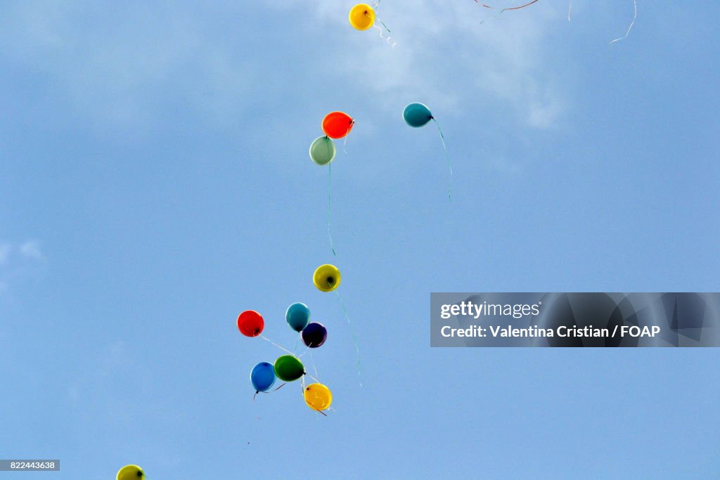 Helium balloons in sky
