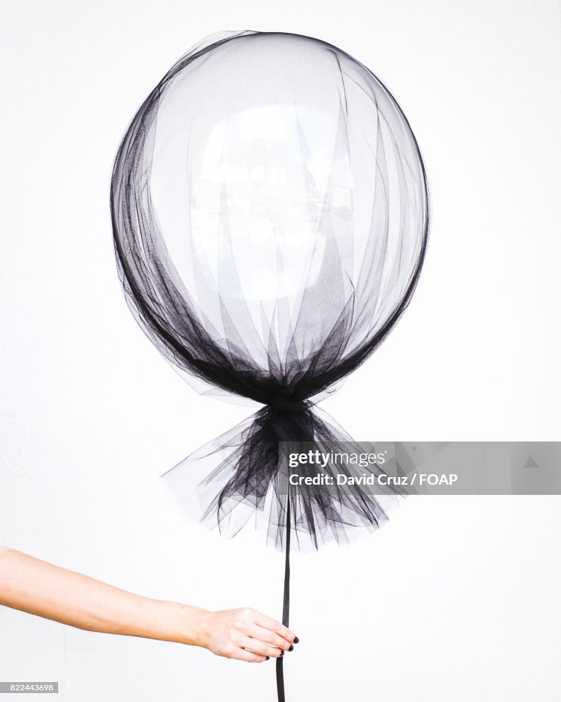 Woman hand holding balloon