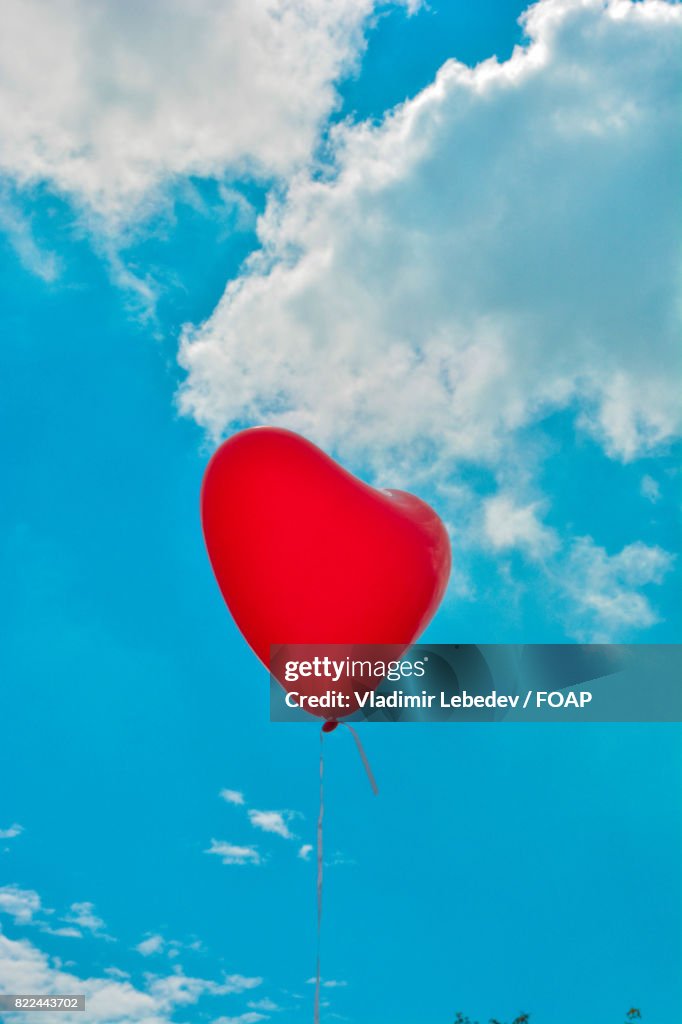Heart shape balloon flying in sky