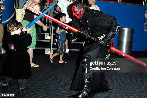 An attendee in a Darth Maul costume interacts with a child at the New York International Children's Film Festival special screening of 'Star Wars:...