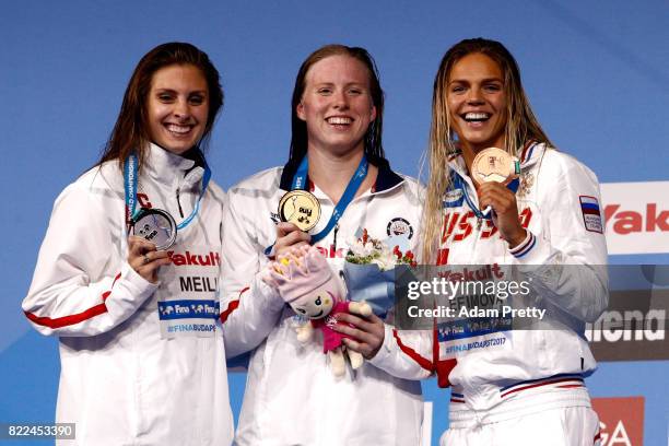 Silver medalist Katie Meili of the United States, gold medalist Lilly King of the United States and bronze medalist Yuliya Efimova of Russia pose...