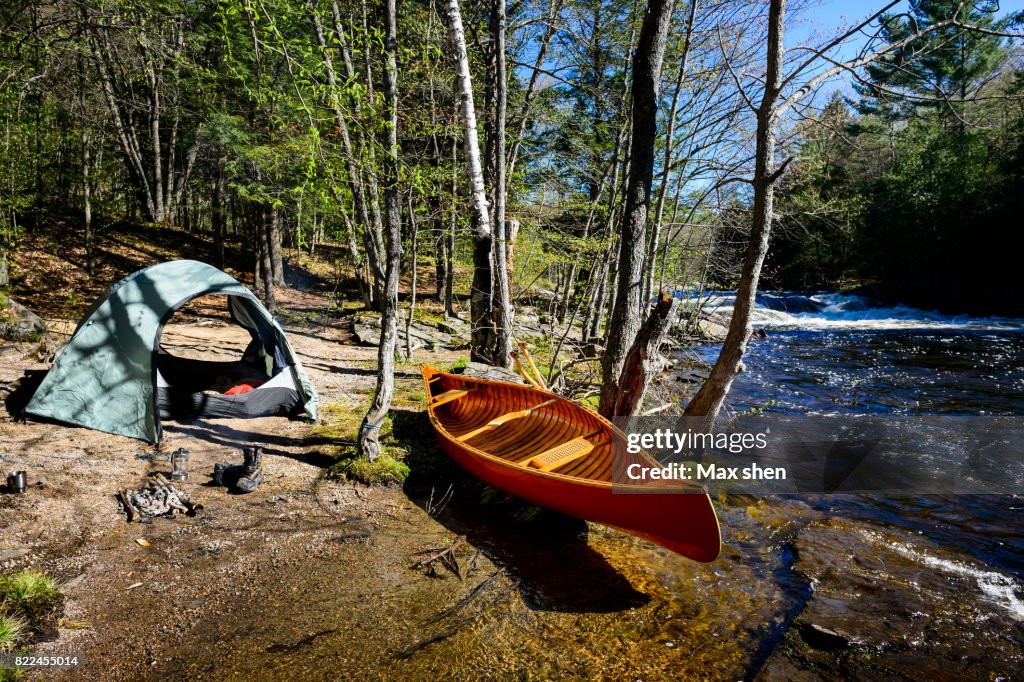 Camping at the riverbank with a canoe