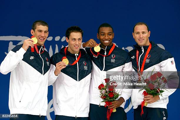Michael Phelps, Garrett Weber-Gale, Cullen Jones, Jason Lezak of the United States pose with the gold medal during the medal ceremony for the Men's 4...