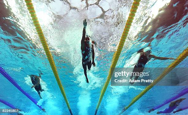 Ashley Callus of Australia, Cullen Jones of the United States and Frederick Bousquet of France compete in the 3rd leg of the Men's 4 x 100m Freestyle...