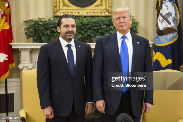 President Donald Trump, right, and Saad Hariri, Lebanon's prime minister, stand for photographs during a meeting in the Oval Office of the White...