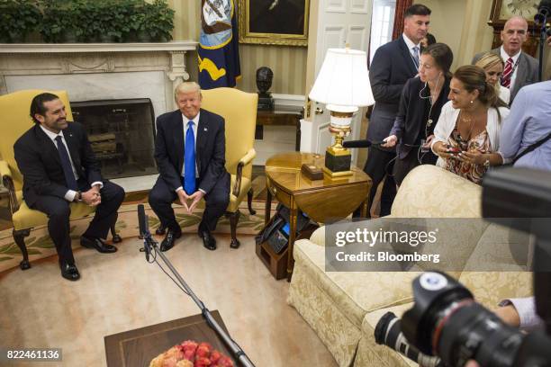 President Donald Trump, center, smiles during a meeting with Saad Hariri, Lebanon's prime minister, right, in the Oval Office of the White House in...