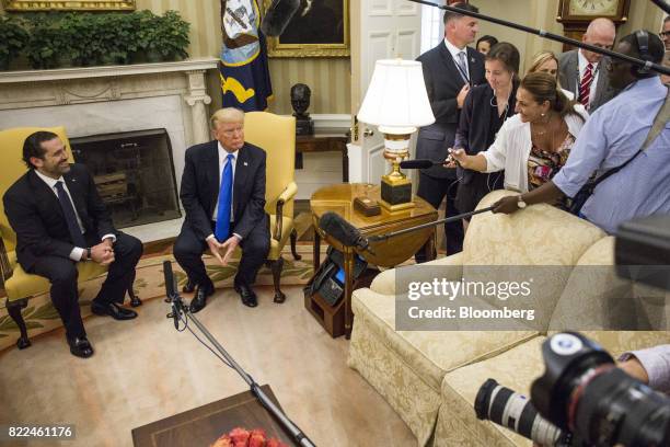 President Donald Trump, center, sits during a meeting with Saad Hariri, Lebanon's prime minister, right, in the Oval Office of the White House in...