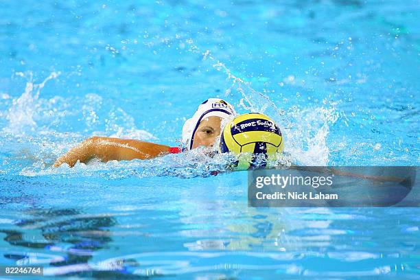 Natalia Shepelina of Russia moves the ball while taking on Italy during their preliminary water polo match at the Ying Tung Natatorium on Day 3 of...