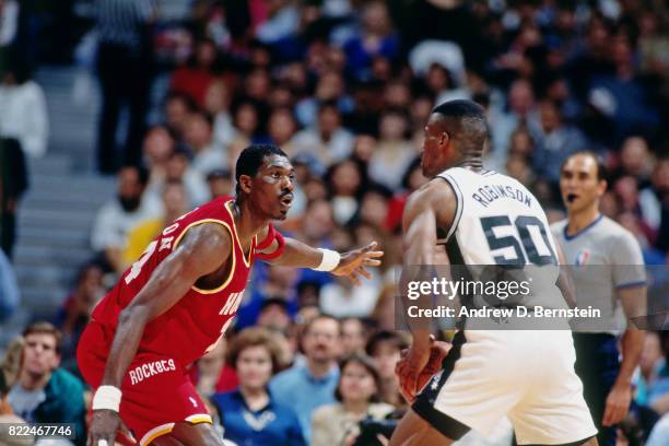 Hakeem Olajuwon of the Houston Rockets defends David Robinson of the San Antonio Spurs during the 1997 All-Star Game on February 9, 1997 at Gund...