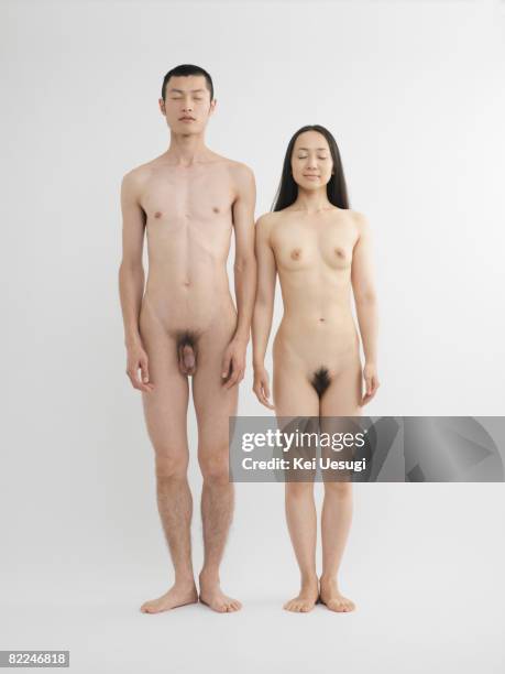 nude man and woman standing together - nudity stock-fotos und bilder