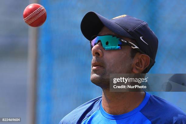 Indian cricketer Ravichandran Ashwin tosses the ball during a practice session ahead of the 1st test match between Sri Lanka and India at Galle...