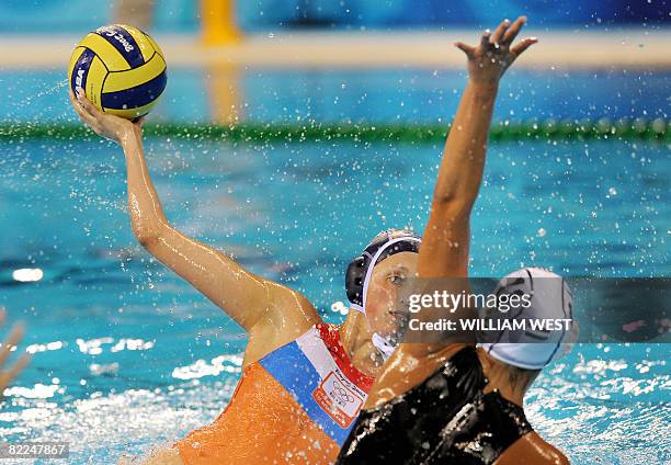 Yasemin Smit of the Netherlands shoots as Agnes Valkai of Hungary attempts to block during their 2008 Beijing Olympics Women's Water Polo match in...