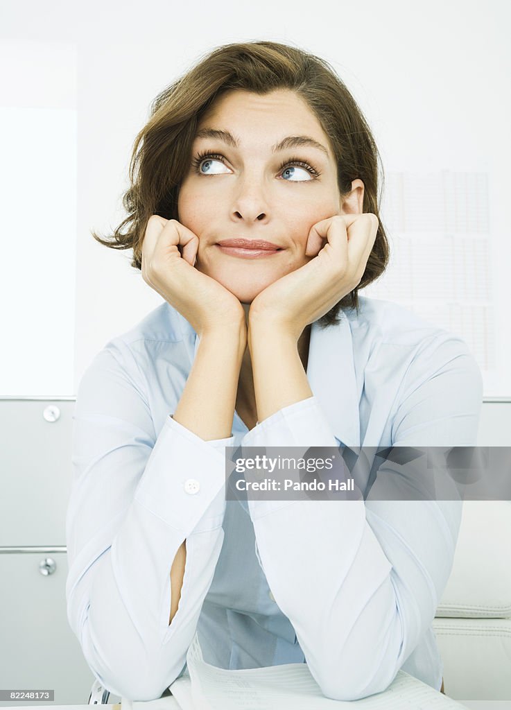 Woman in office, looking up