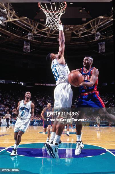 Lindsey Hunter of the Detroit Pistons looks to pass against the Charlotte Hornets during a game at the Charlotte Coliseum in Charlotte, North...