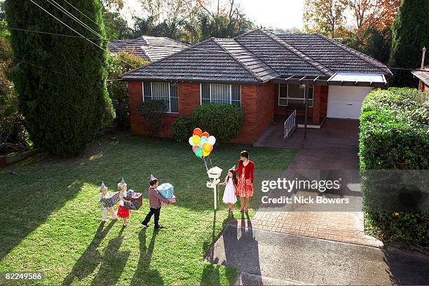 children arriving at birthday party with gifts - children birthday party foto e immagini stock