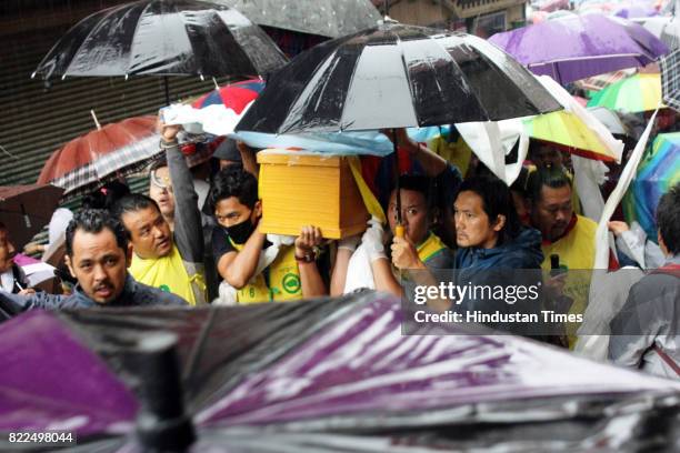 Exile Tibetans carry a coffin containing the body of Tenzin Choeying on July 25, 2017 in Dharamsala, India. Tenzin Choeying, a 19-year-old student...