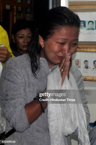 An exile Tibetan offers a ceremonial scarf to a coffin containing the body of Tenzin Choeying on July 25, 2017 in Dharamsala, India. Tenzin Choeying,...