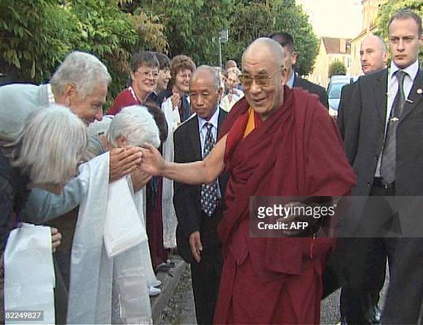 Grab released by the association "Ocean de sagesse" shows Tibetan spiritual leader, The Dalai Lama shakes hands with people upon his arrival on...