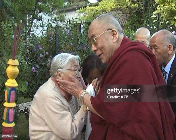 Grab released by the association "Ocean de sagesse" shows Tibetan spiritual leader, The Dalai Lama salutes a woman upon his arrival on August 11,...