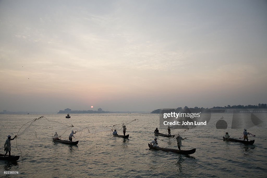 Fishermen throwing fishing nets in Cochin, India